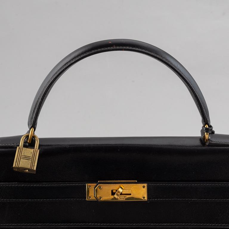 Hermès,a black leather 'Kelly 32' handbag, 1975.