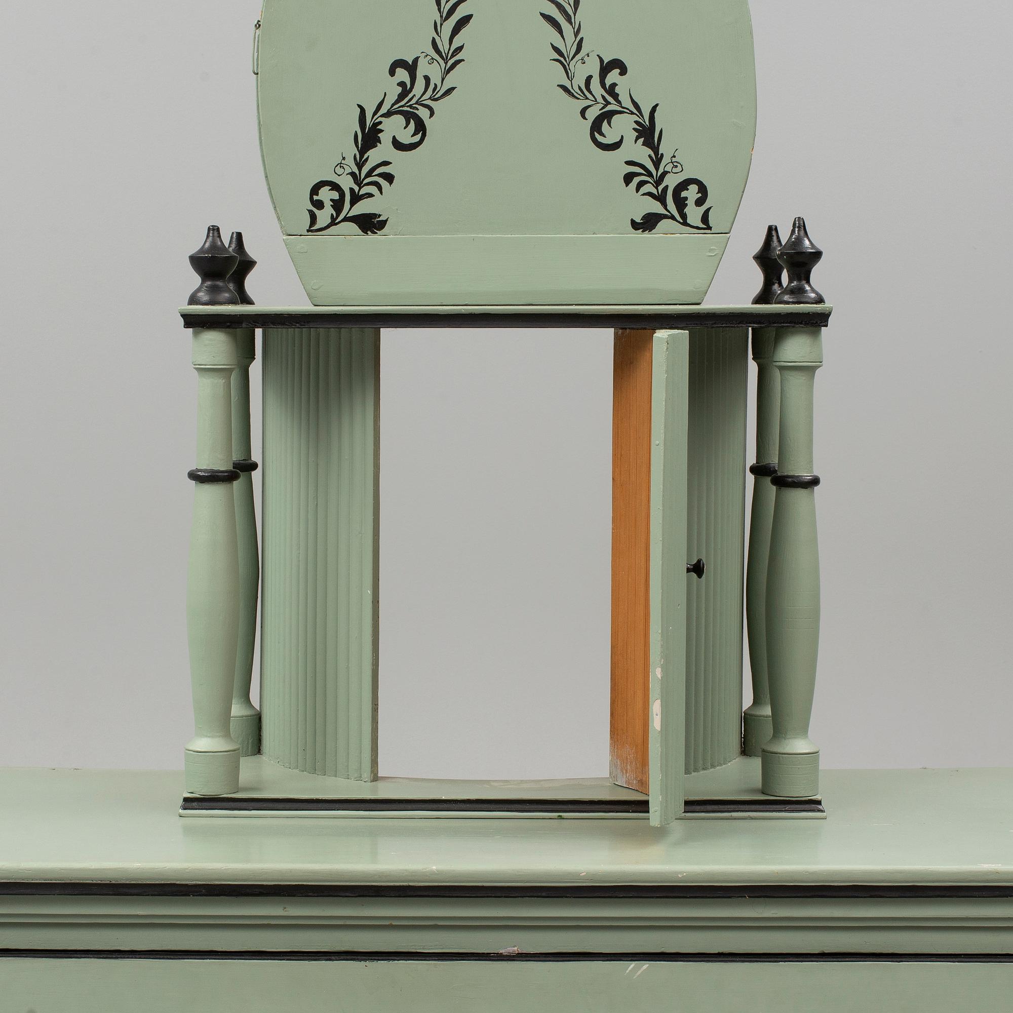 A combined clock and chest of drawers from late 19th  century.