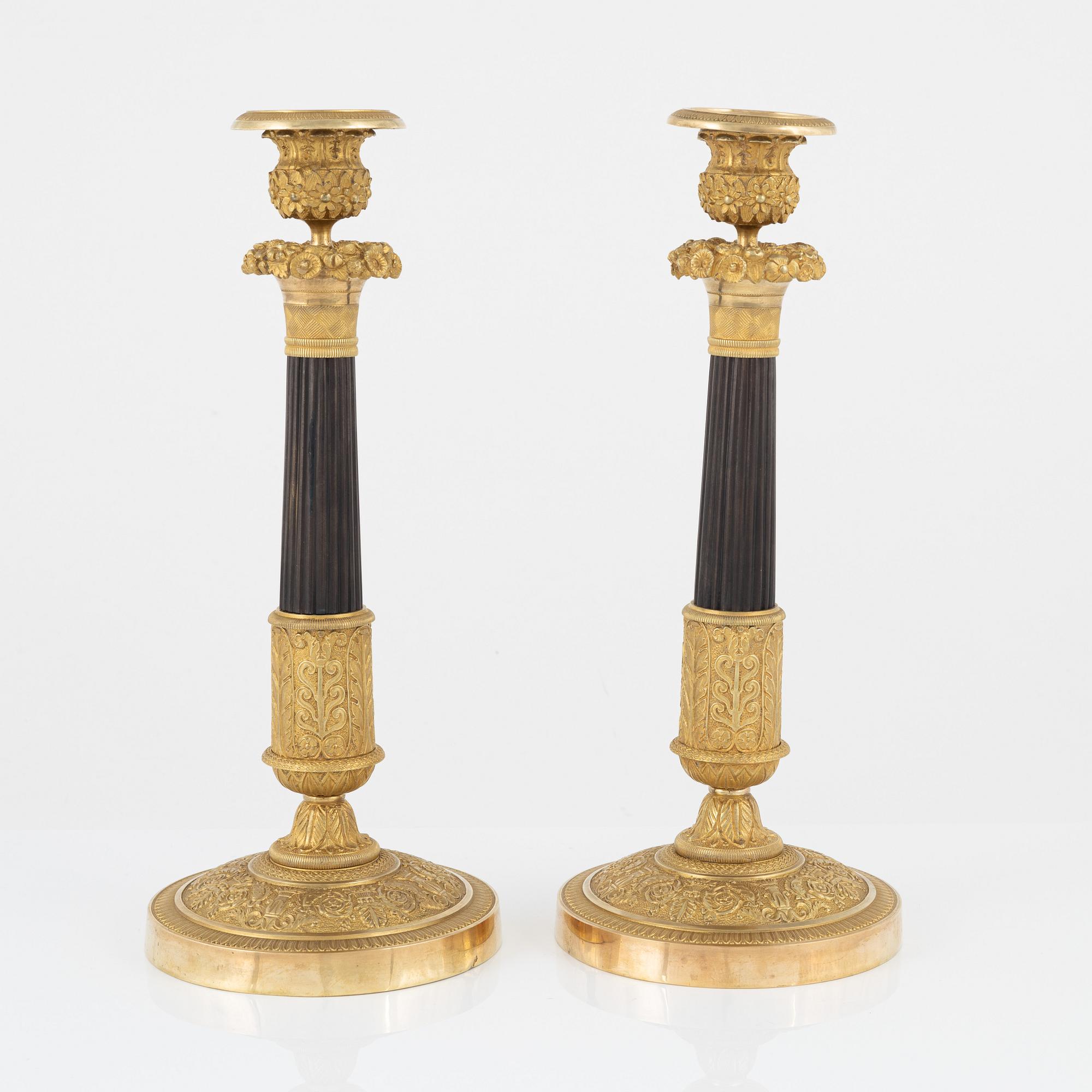 A pair of French Empire ormolu and patinated bronze candlesticks, early 19th century.