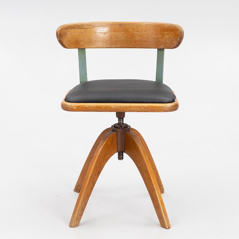 A 1920's swivel desk chair.