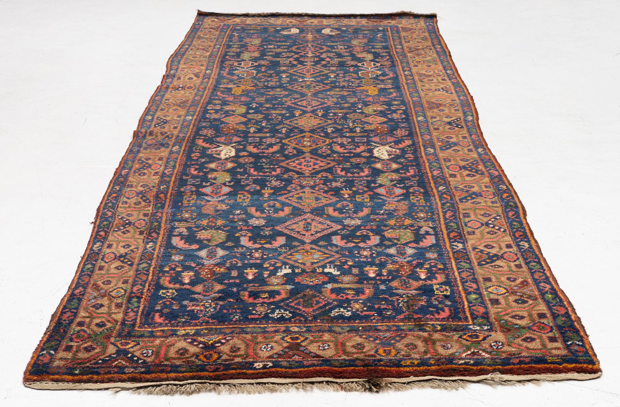 A semi-antique Northwest Persian runner, c. 388 x 94 cm.