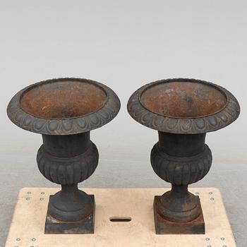 A pair of cast iron plant pots, late 20th century.