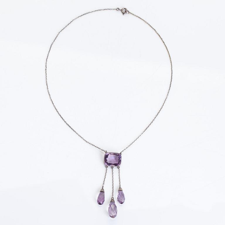 A silver and faceted amethyst necklace.