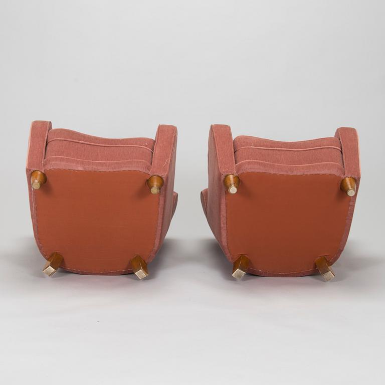 A pair of mid-20th century armchairs.