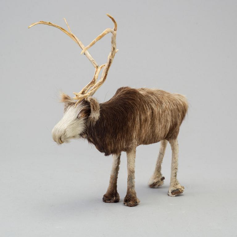 A Sami reindeer fur figure of a reindeer.