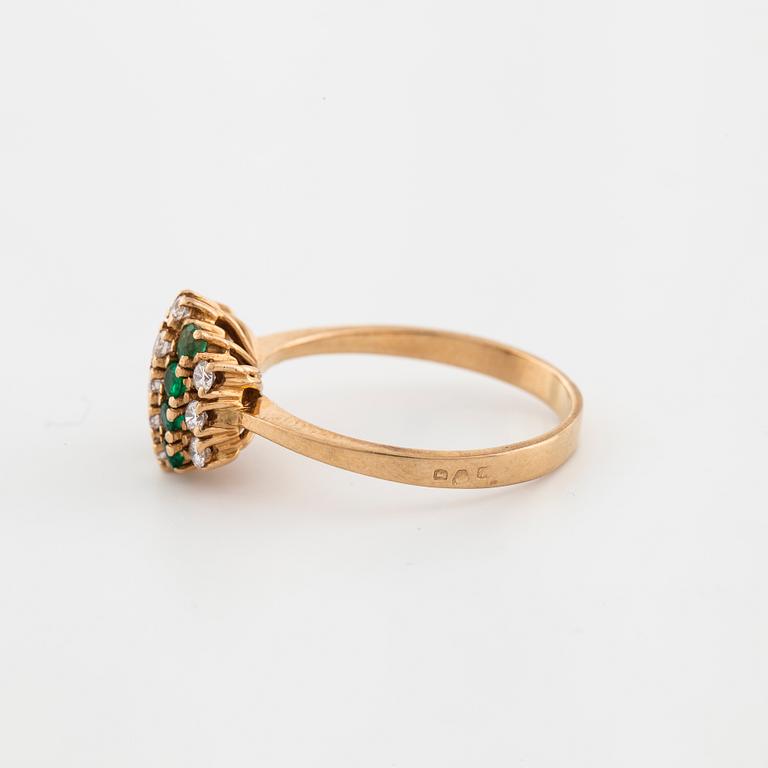 An emerald and brilliant cut diamond ring.