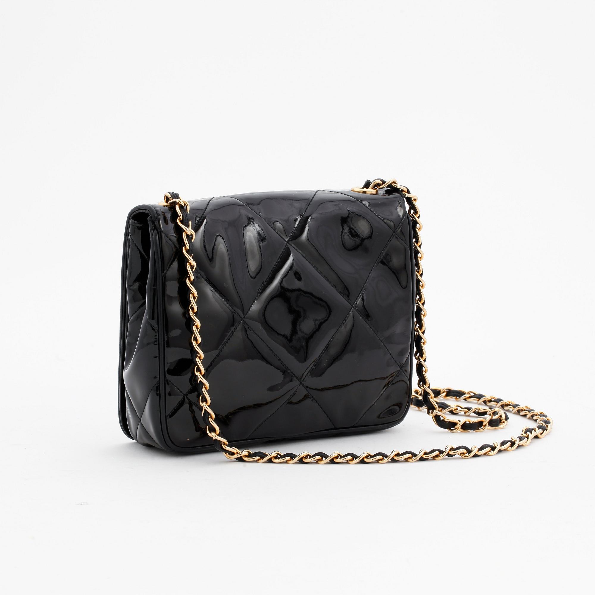CHANEL, a black patent leather shoulder back.