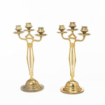 Jugend/Art Nouveau, A pair of brass candelabra, early 20th century.