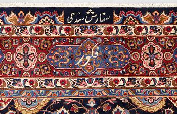 A Kashmar carpet from eastern Iran of 'Ardabil' design, signed, c 338 x 245 cm.