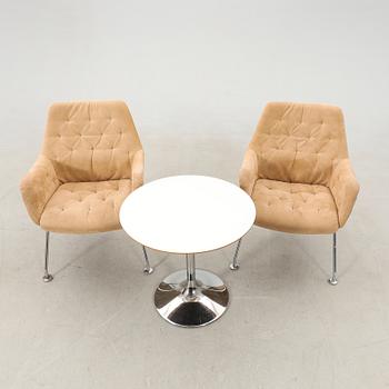 Bruno Mathsson, a pair of "Mirja" armchairs for DUX, late 20th century, and a table.