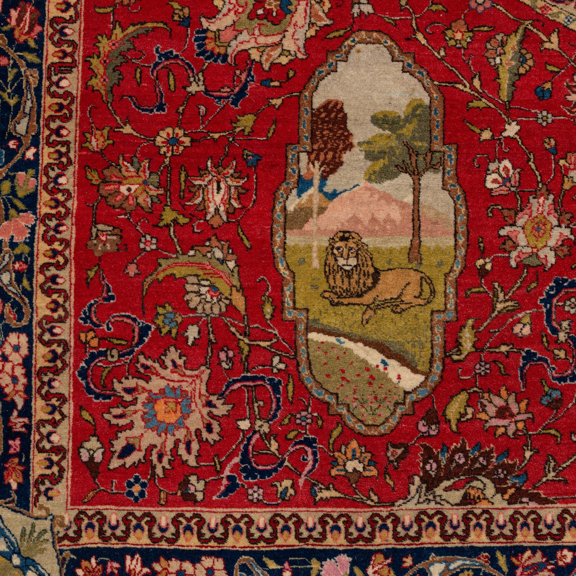 A signed semiantique pictoral Tabriz carpet, c. 269 x 189 cm.