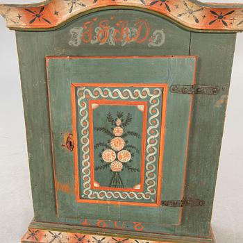 A painted Swedish wall cabinet dated 1808.