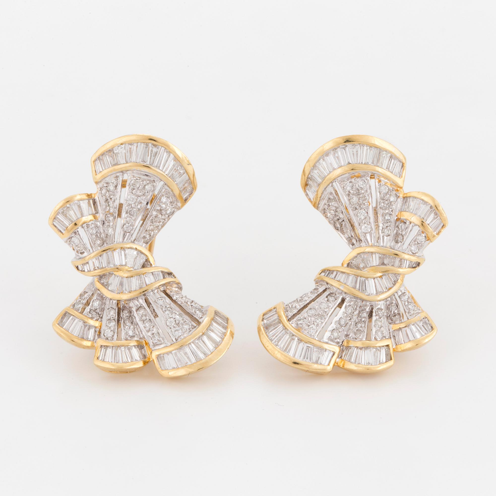 A pair of earrings in the shape of bows set with round, brilliant and tapered, baguette-cut diamonds.