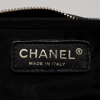 CHANEL, a black leather bag with beige stitching.