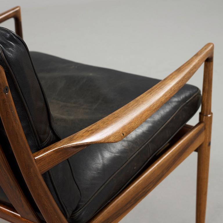 Ib Kofod-Larsen, a pair of palisander and black leather 'Samsö' armchairs, 1960's, for Thysell's, Anderslöv, Sweden.