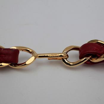 CHANEL, a red leather belt.