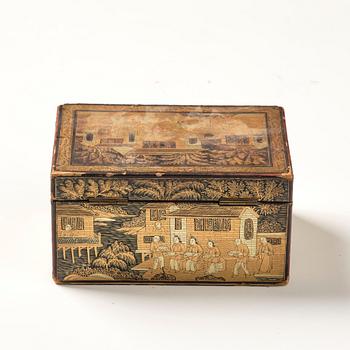 A lacquer tea box and a blanc de chine cup, Qing dynasty 18/19th century.