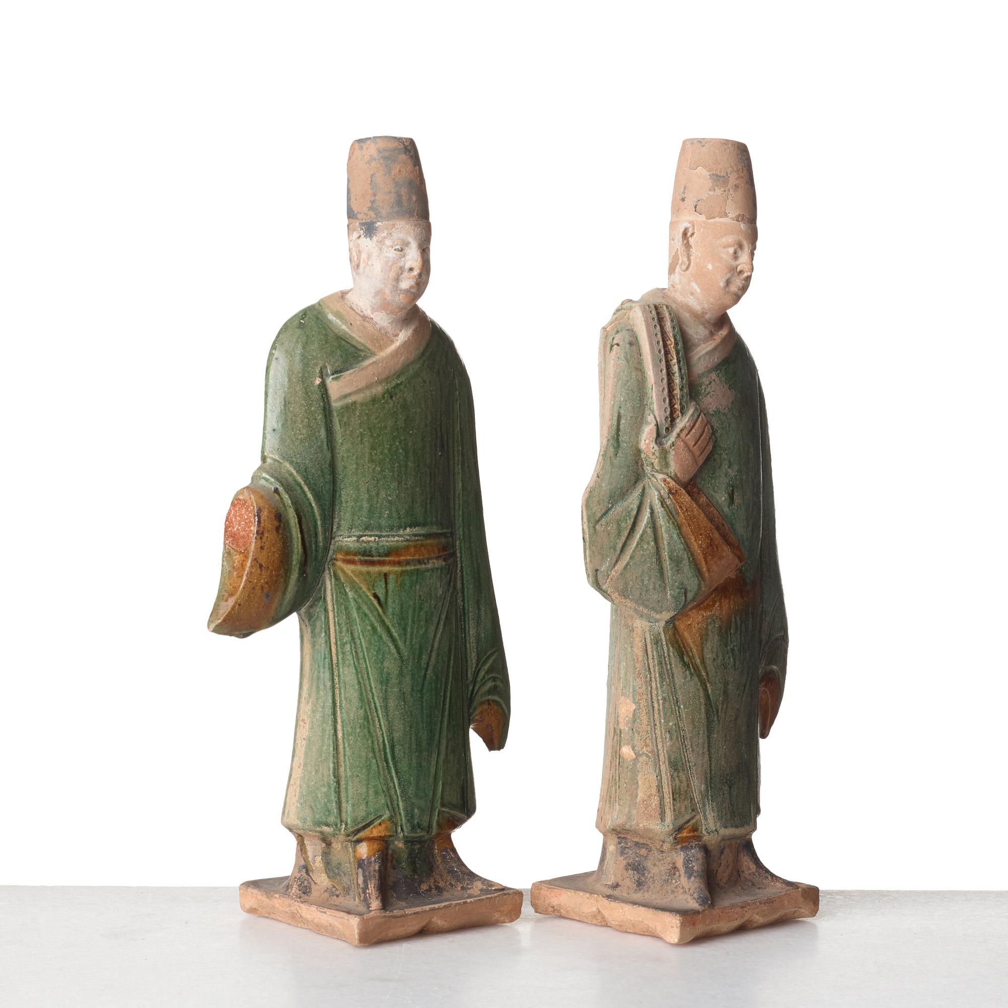 Two green and yellow glazed pottery figures of Ming officials, Ming style, 20th Century.