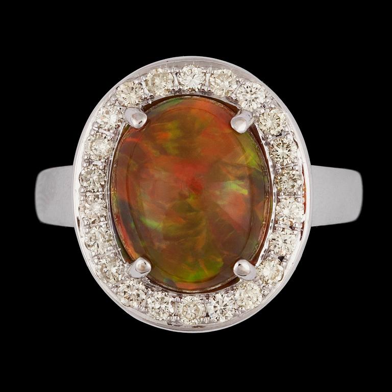 A cabochon cut opal, 3.25 cts, and brilliant cut diamond ring, tot. 0.53 cts.