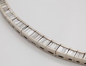 A platinum necklace set with tapered baguette-cut diamonds.