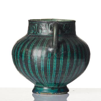 A Kashan Silhouette ware turquoise glazed pottery jug, central Iran, circa 1200.