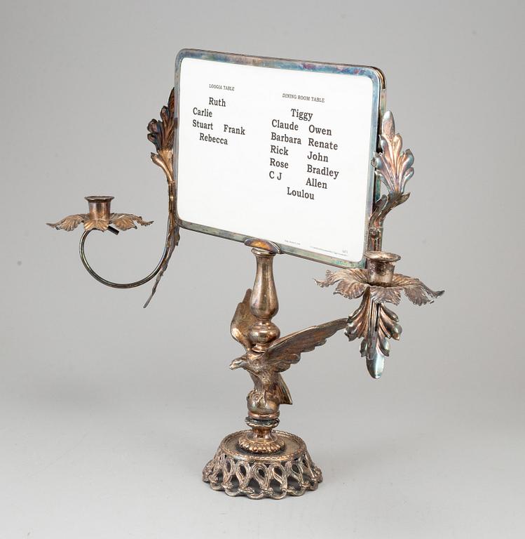 A plated candelabra with table setting card. Rococo-style.