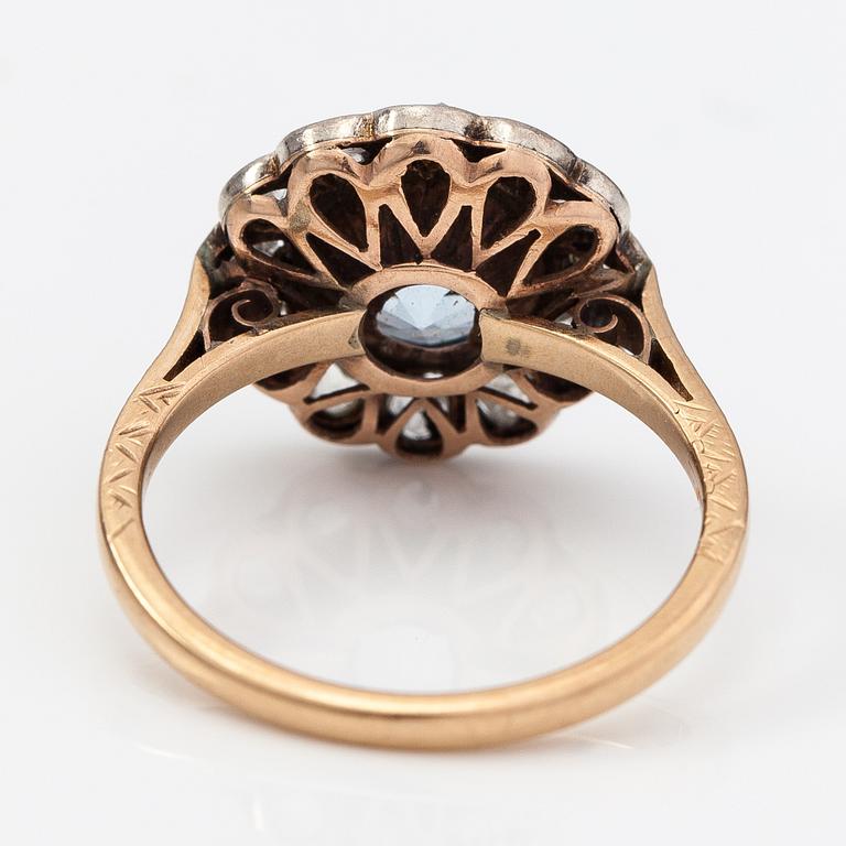 A 13-14K gold ring with a synthetic spinelle and rose-cut dimaonds.