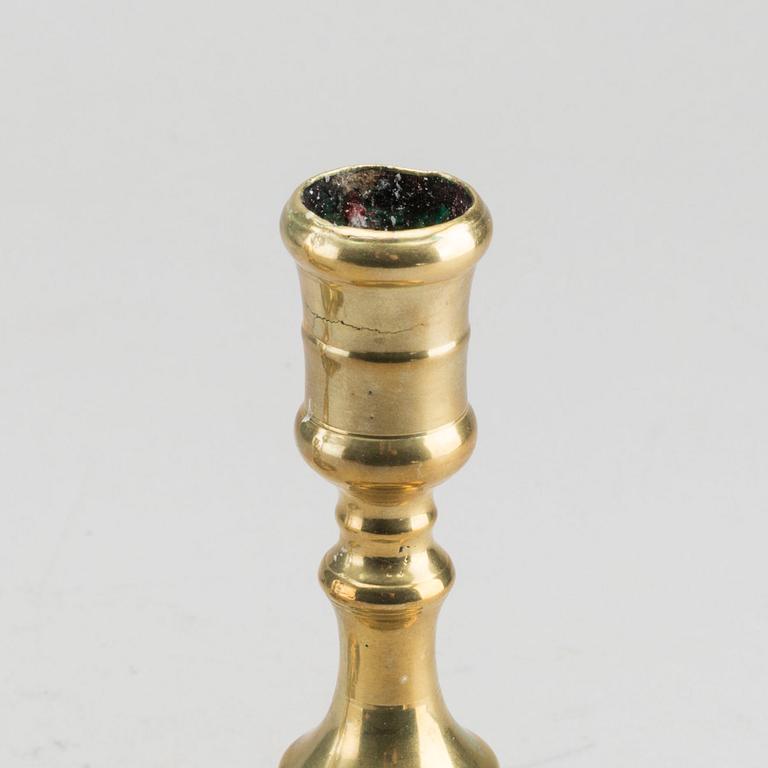 A set of two of brass candle sticks mid 18th century.