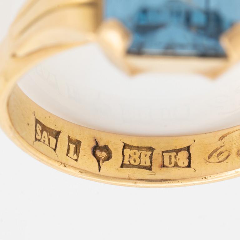 18K gold and synthetic blue spinel ring.