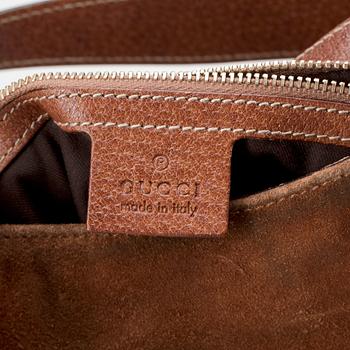 GUCCI, a brown suede shoulder bag.