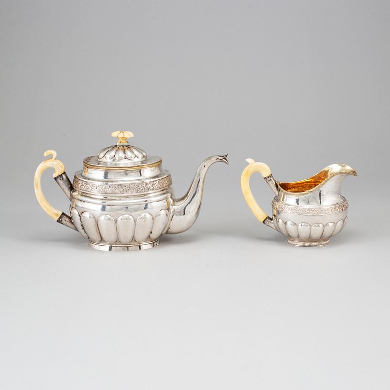 A Russian silver teapot and a parcel gilt silver creamer, Gustav Lindgren and Elias Modig, St Petersburg 1826-27.