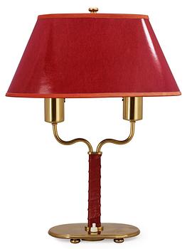 469. A Josef Frank brass and red leather table lamp by Svenskt Tenn.