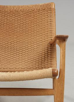 A Hans J Wegner 'CH-25' oak easy chair, Carl Hansen & Son, Denmark.