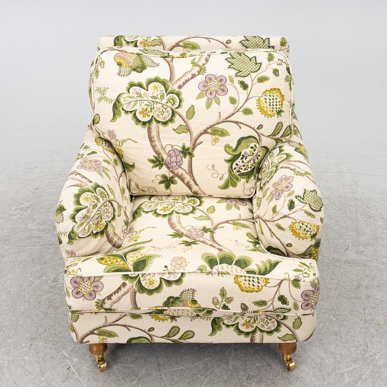A 'Howard' armchair with footstool, Englesson.