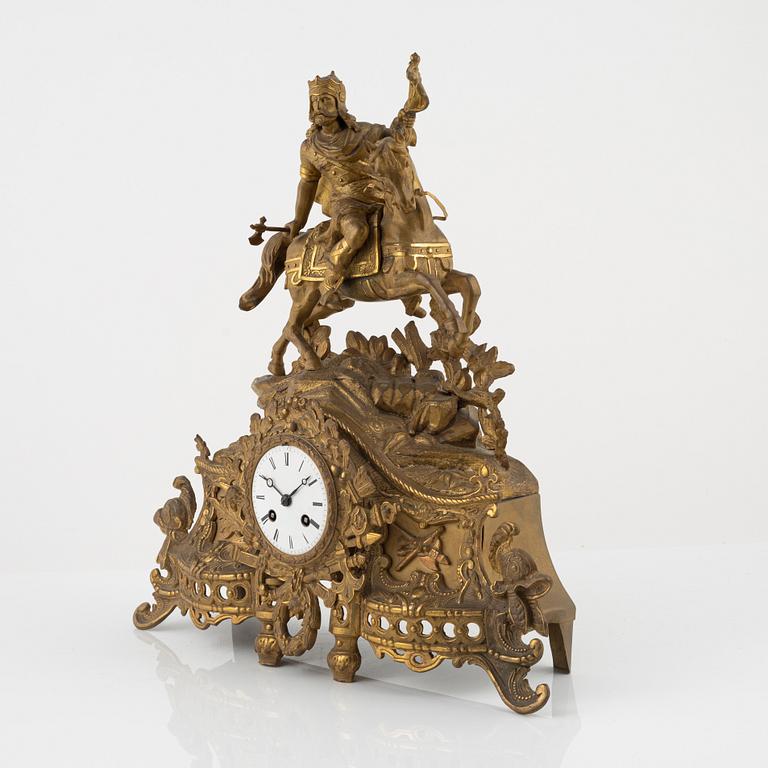 A brass mantle clock from around the year 1900.