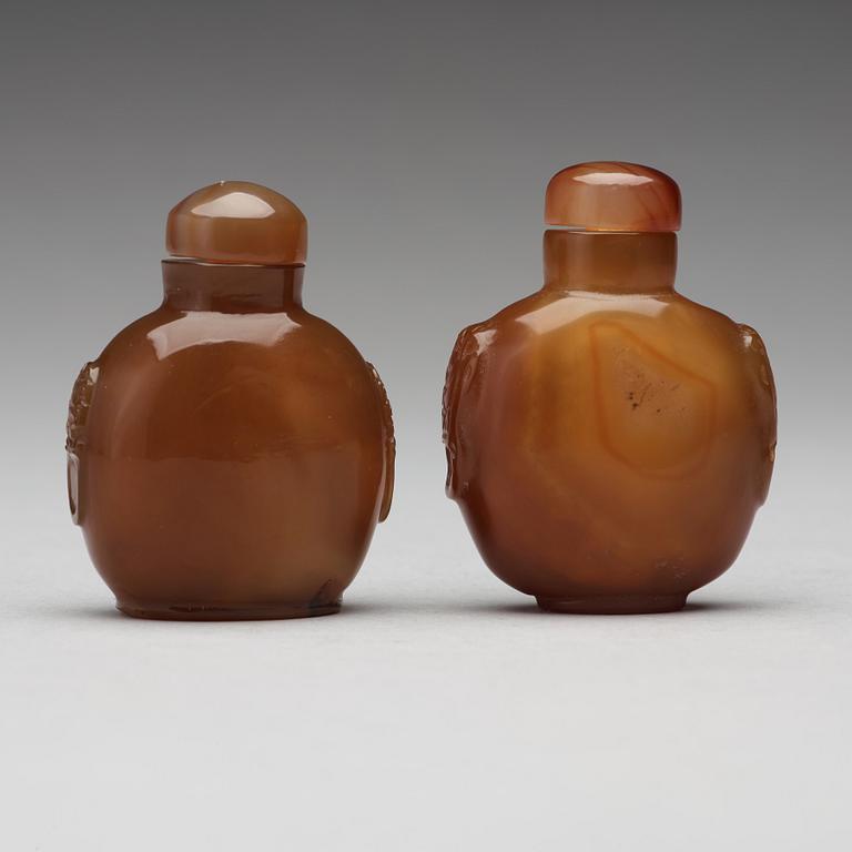 Two Chinese agathe snuff bottles with stoppers.