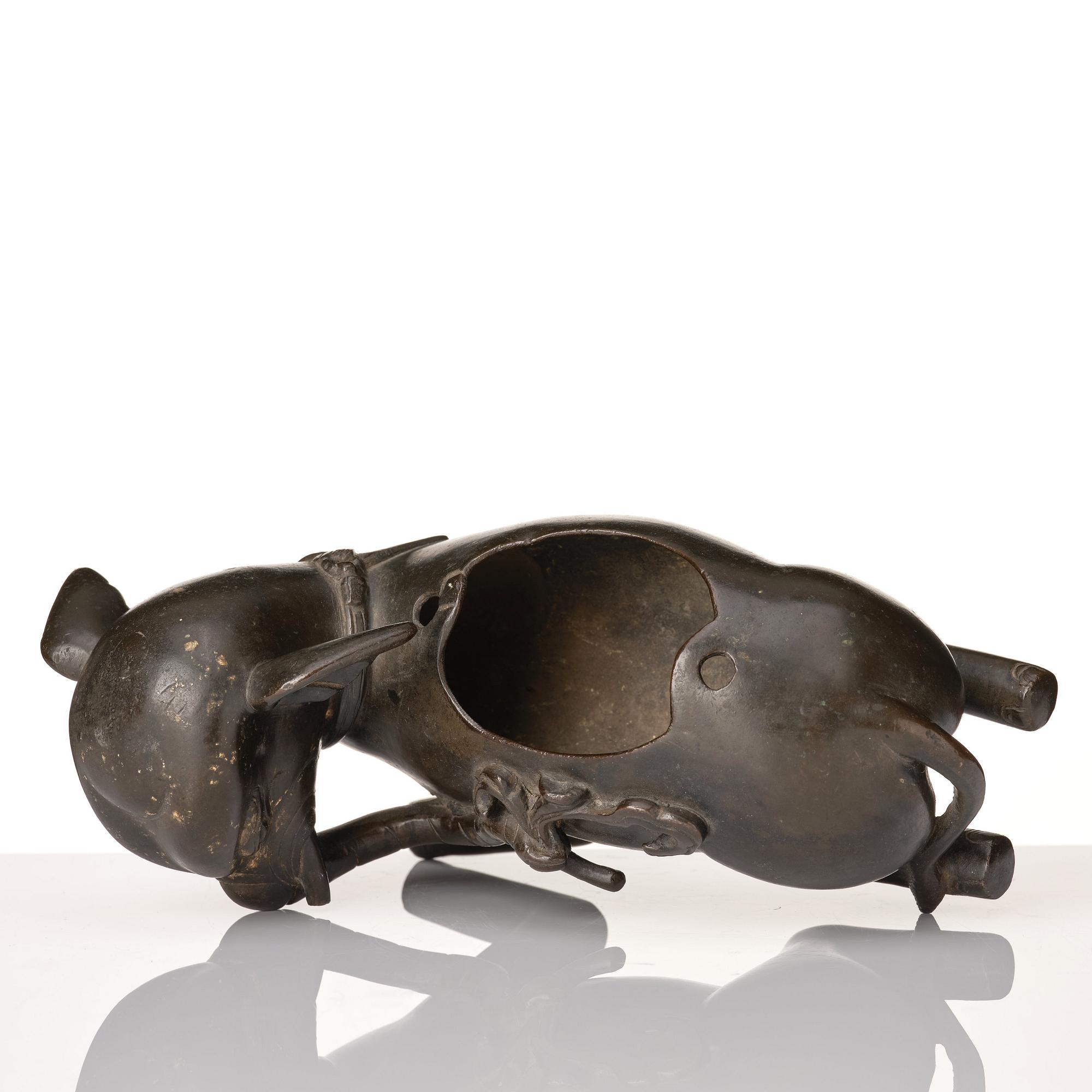 A bronze figure/censer of a reclining elephant, Qing dynasty, 19th Century.