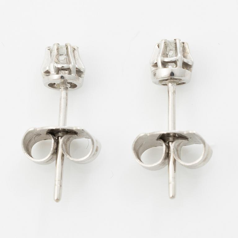 A pair of 18K white gold earrings with round brilliant-cut diamonds.