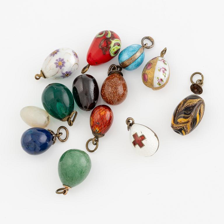Bracelet with charms in the shape of eggs, the bracelet is 14K gold and 13 loose charms in the shape of eggs.