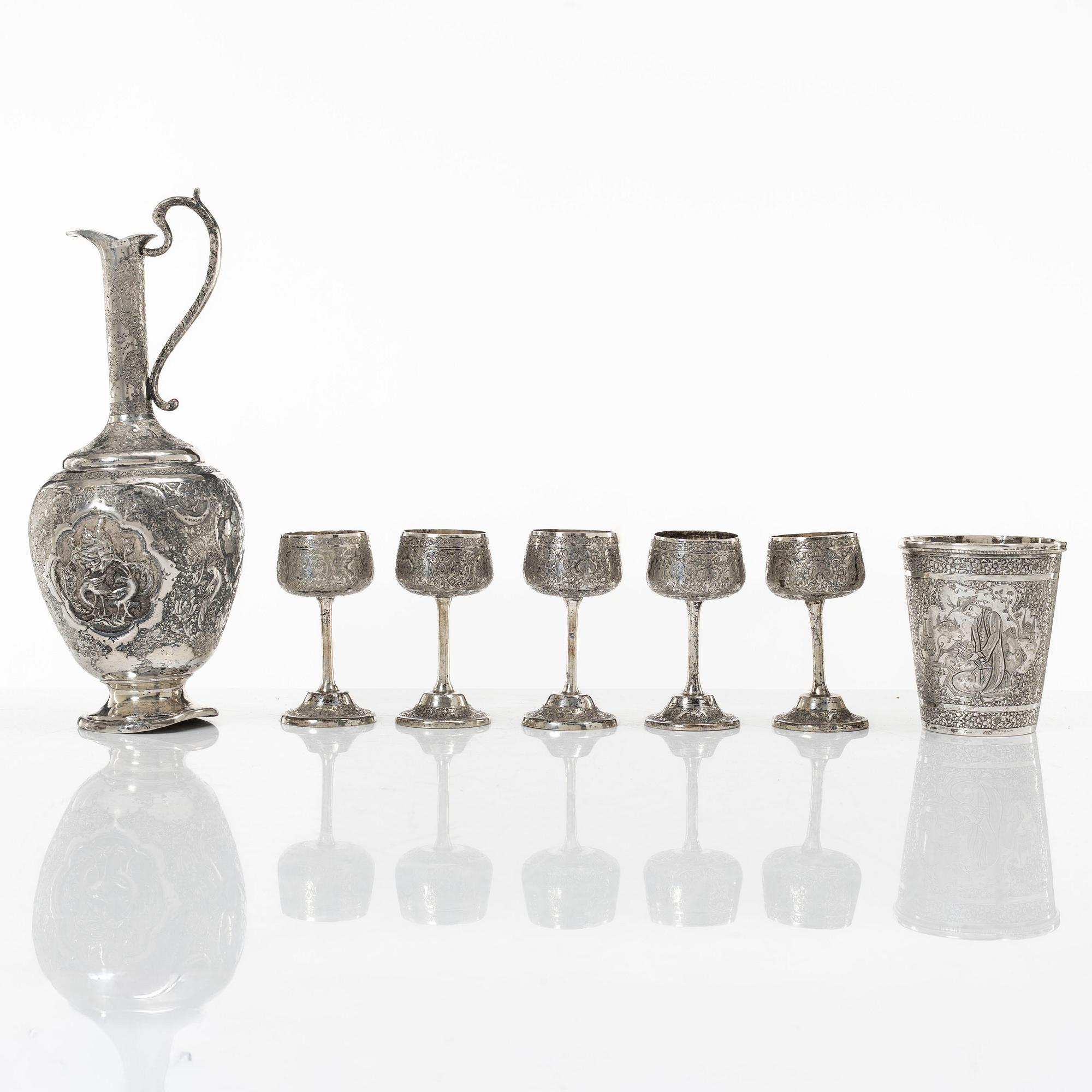 A Persian silver pitcher with five stemmed cups and a beaker, first part of the 1900s.