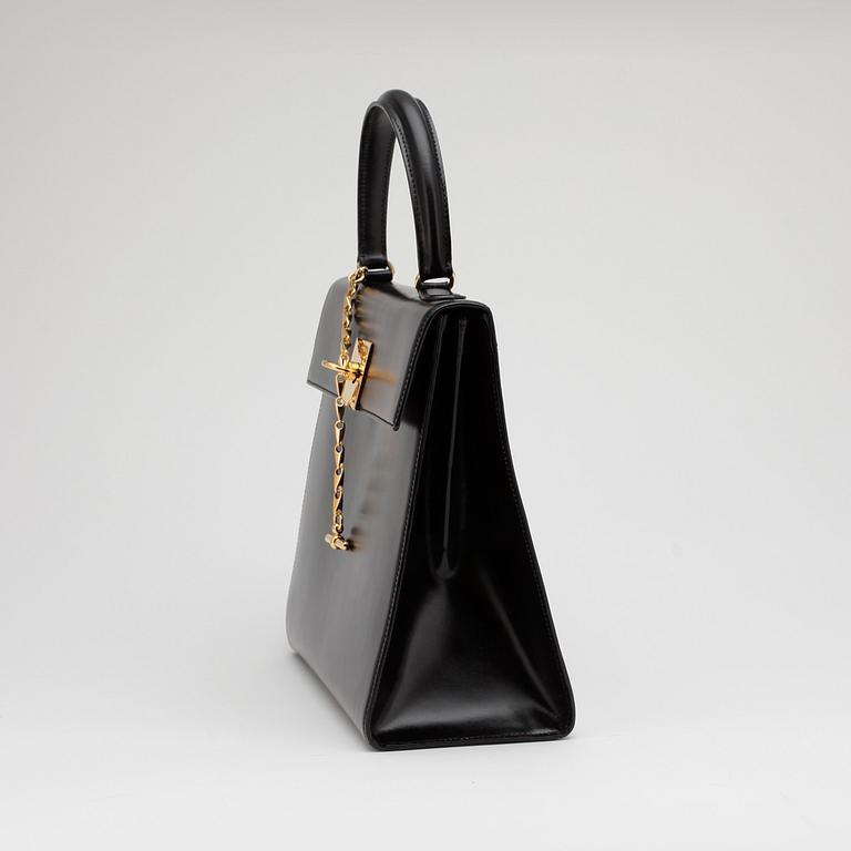 CÉLINE, a black leather top handle purse.