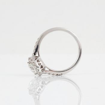 A brilliant-cut diamond ring. Center stone 1.03 cts F/VS1, surrounded by 0.36 ct pavé-set diamonds.