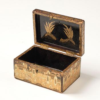 A lacquer tea box and a blanc de chine cup, Qing dynasty 18/19th century.