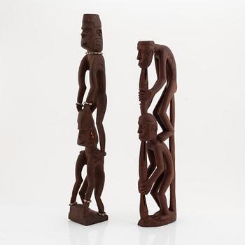 A group of three wooden Asmat sculptures, 20th Century.