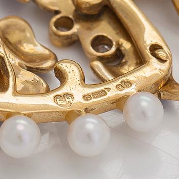 An 18K gold pendant, with cultured pearls, enamel and diamonds totalling approximately 0.07 ct, England.