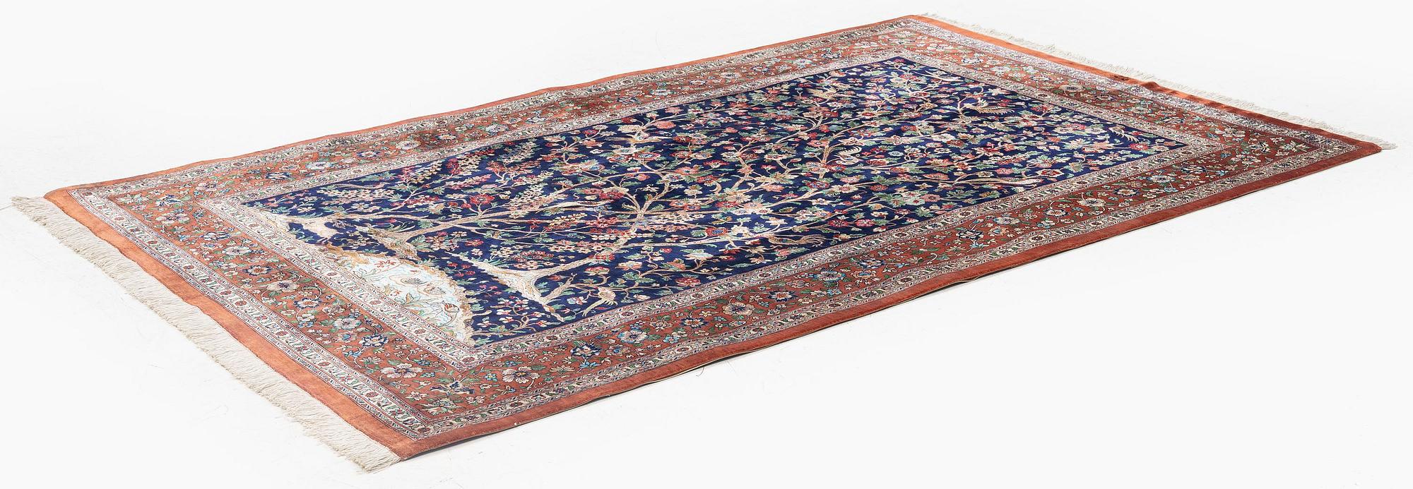 A signed pictoral silk Qum rug, c. 203 x 127 cm.