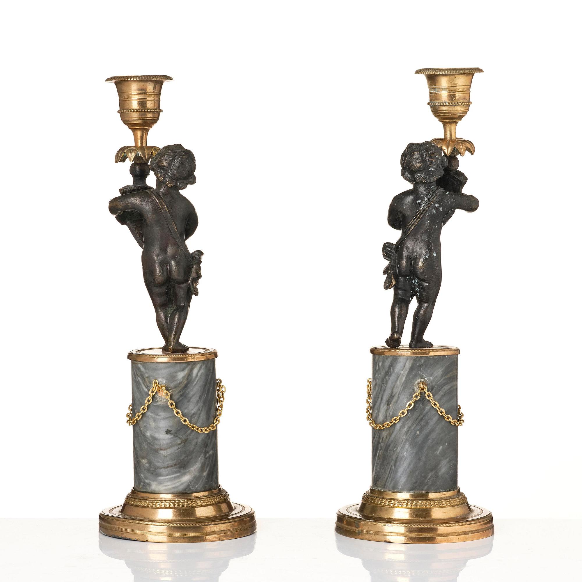 A pair of French Louis XVI ormolu and marble candlesticks, late 18th century.