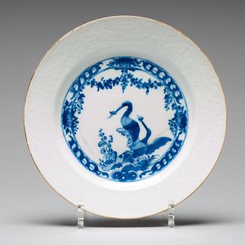 A set of four blue and white armorial dinner plates, Qing dynasty, 18th Century.