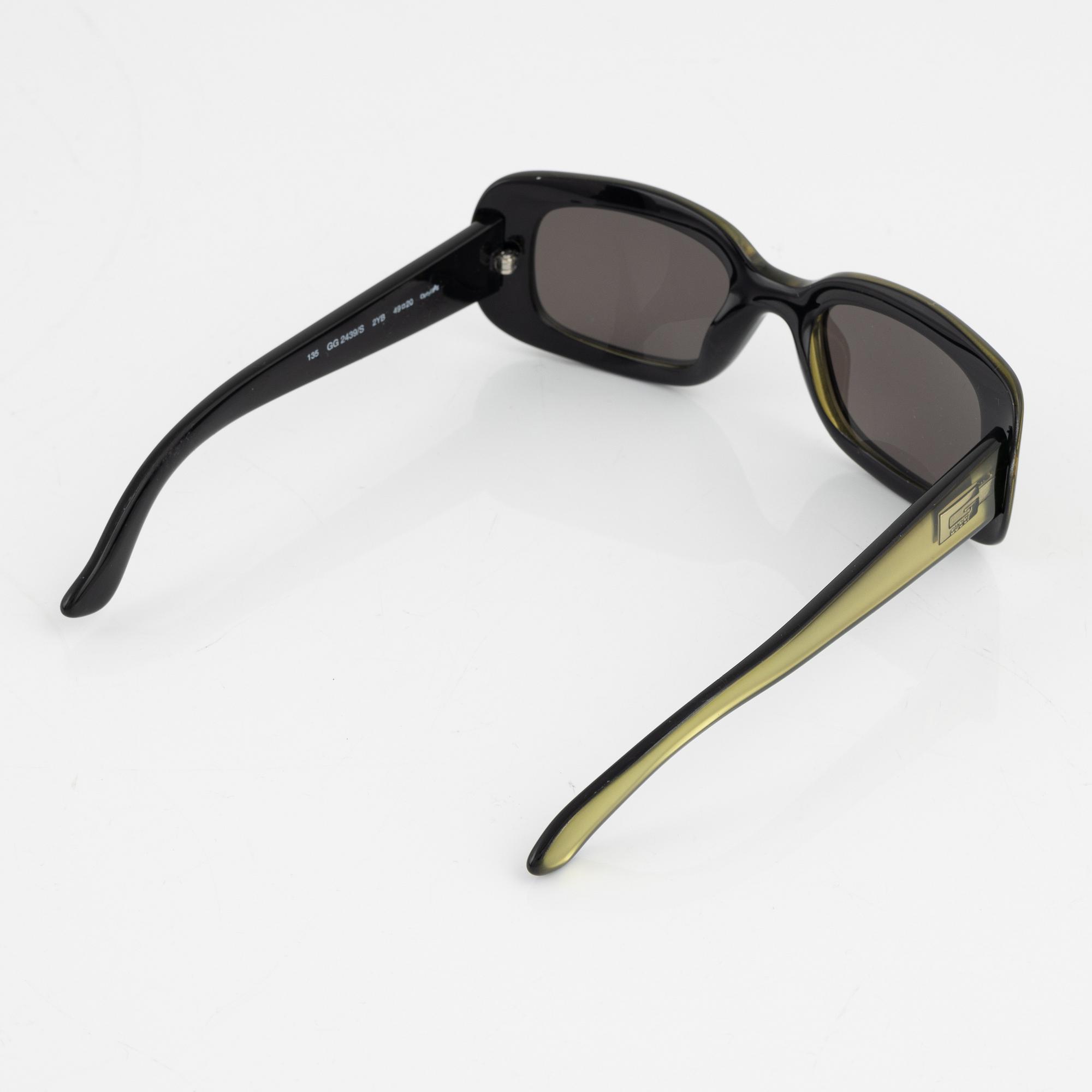 Gucci, a pair of green sunglasses.