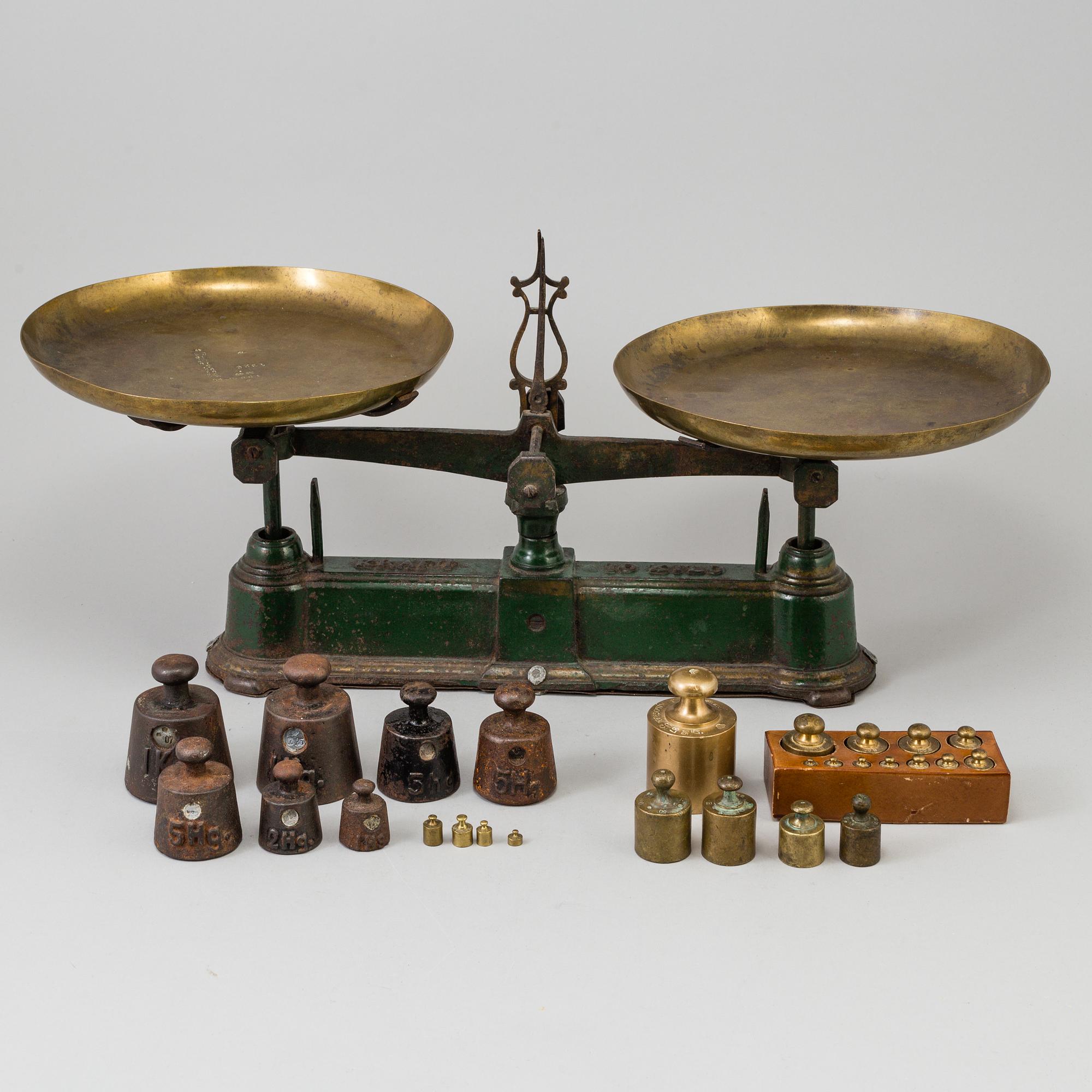A 20th century cast iron balance with brass and iron weights, partly Skultuna, Sweden.